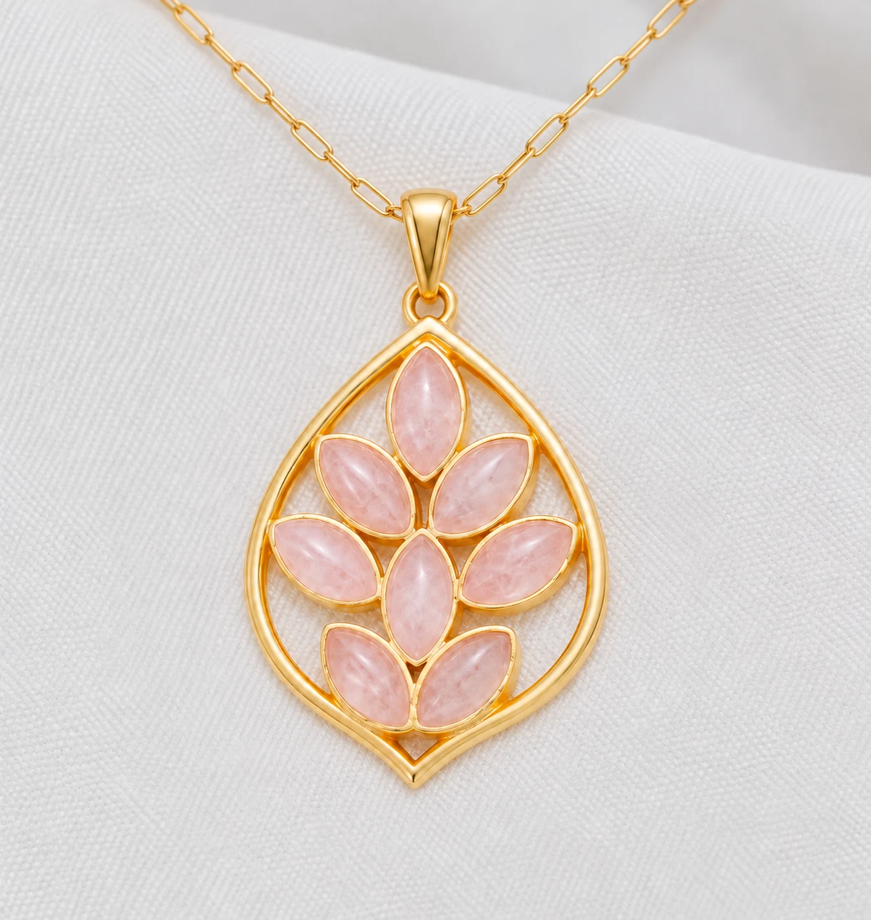 Rose quartz leaf pendant on a gold paperclip chain